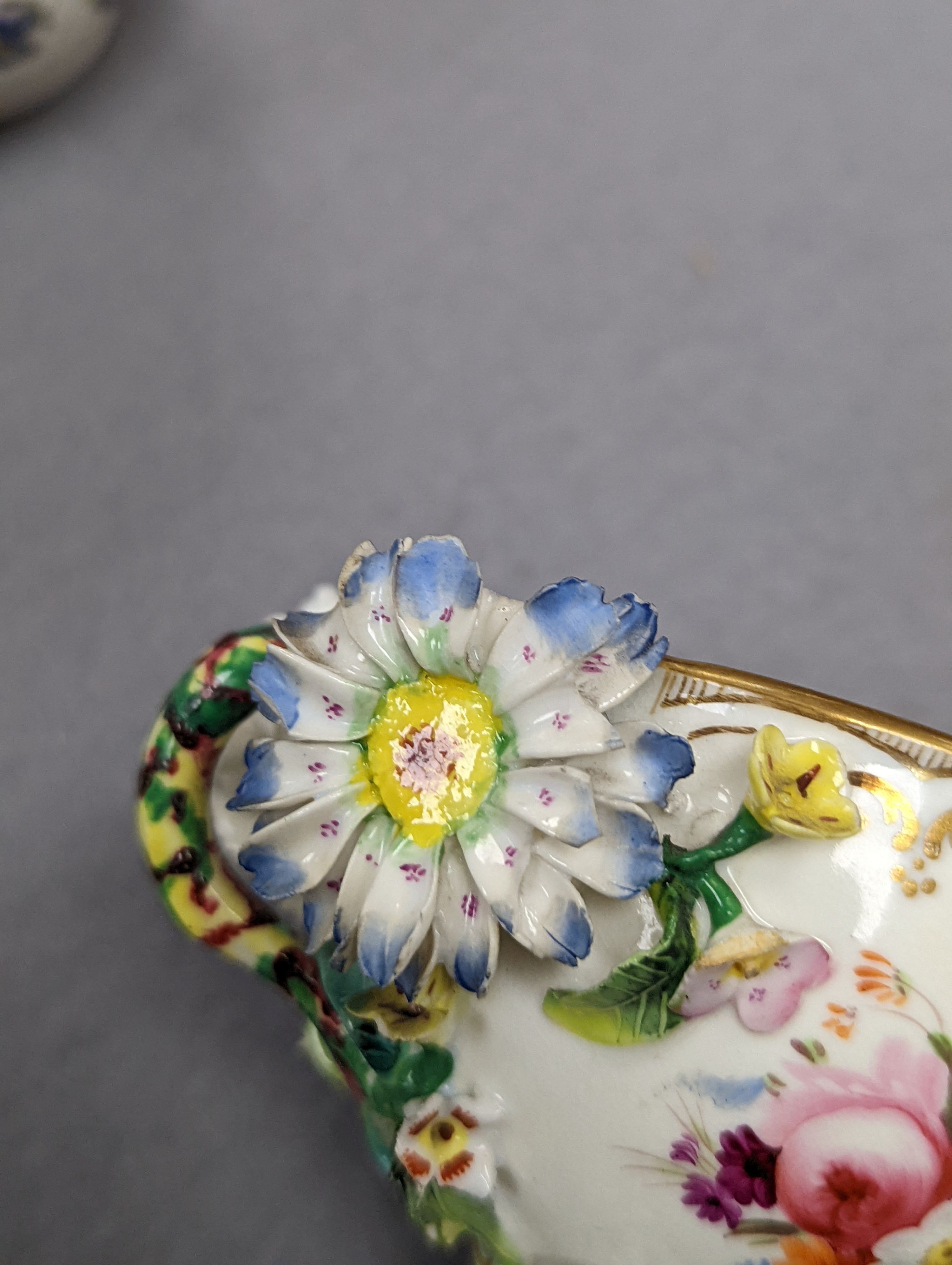 An 18th century Mennecy porcelain cup and cover, a Meissen style cup and cover, an English porcelain floral encrusted double inkwell and cover and a similar jar and cover